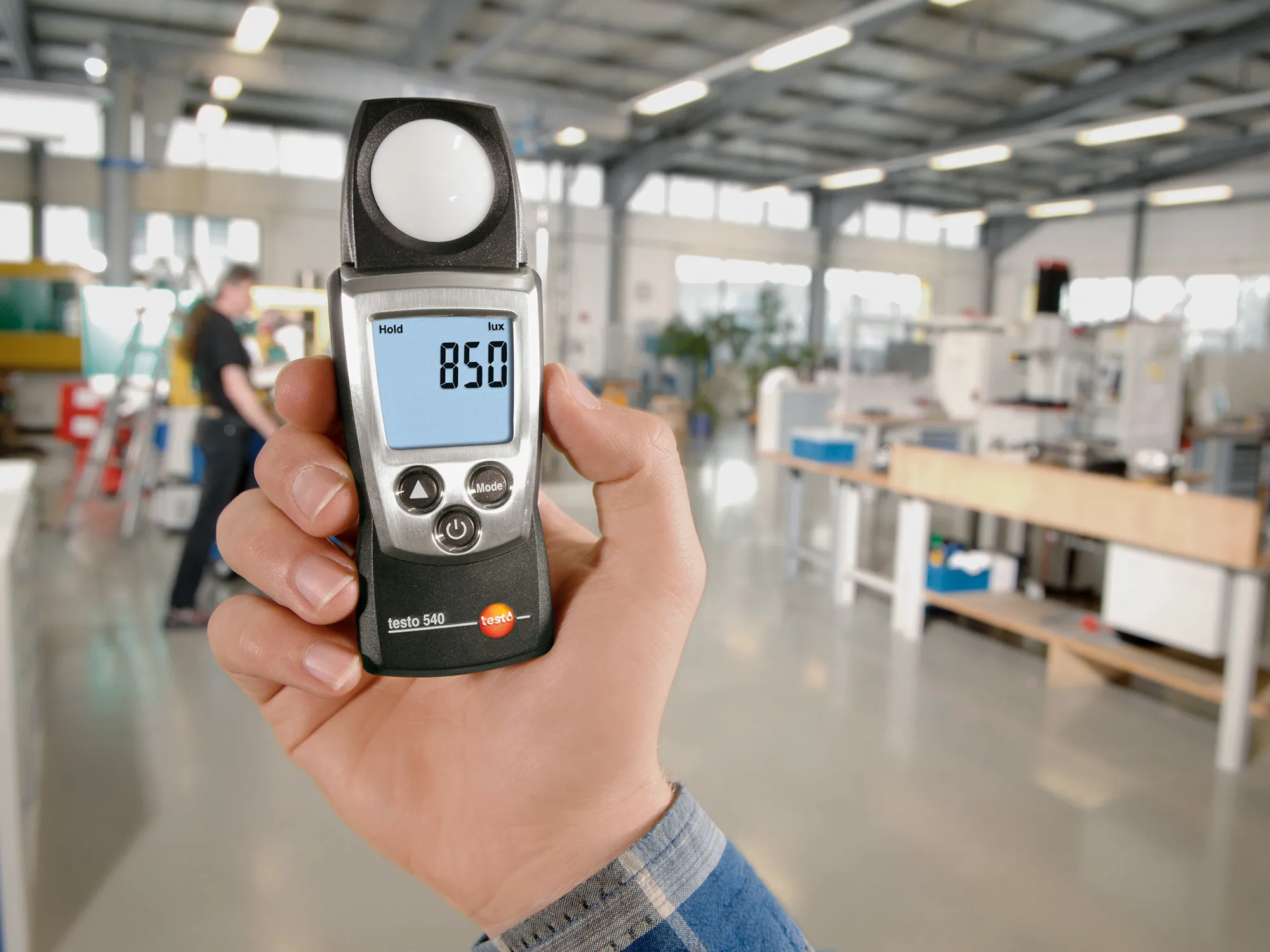Engineer performing workplace illumination survey